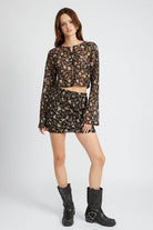 Trendy floral lace skirt outfit featuring a matching crop top and boots for a stylish look