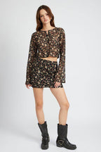 Trendy floral lace skirt outfit featuring a matching crop top and boots for a stylish look
