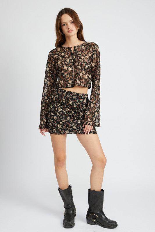 Trendy floral lace skirt outfit featuring a matching crop top and boots for a stylish look