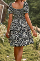 Floral print a line dress featuring puff sleeves and a tiered skirt, perfect for summer outings