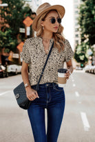Stylish floral print v neck blouse paired with high-waisted jeans and a hat for a trendy look