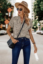 Women's floral print v neck blouse from VacationGrabs styled with high-waisted jeans and a trendy hat