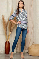 Women's floral roll up sleeve top by Shopin LA, paired with jeans for a stylish look