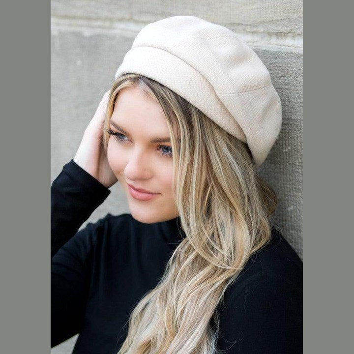 Elegant beige fold over beret for travel, perfect accessory for stylish women on the go