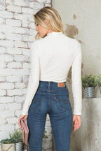 Andante USA Women's form-fitting travel bodysuit in white with long sleeves and textured design