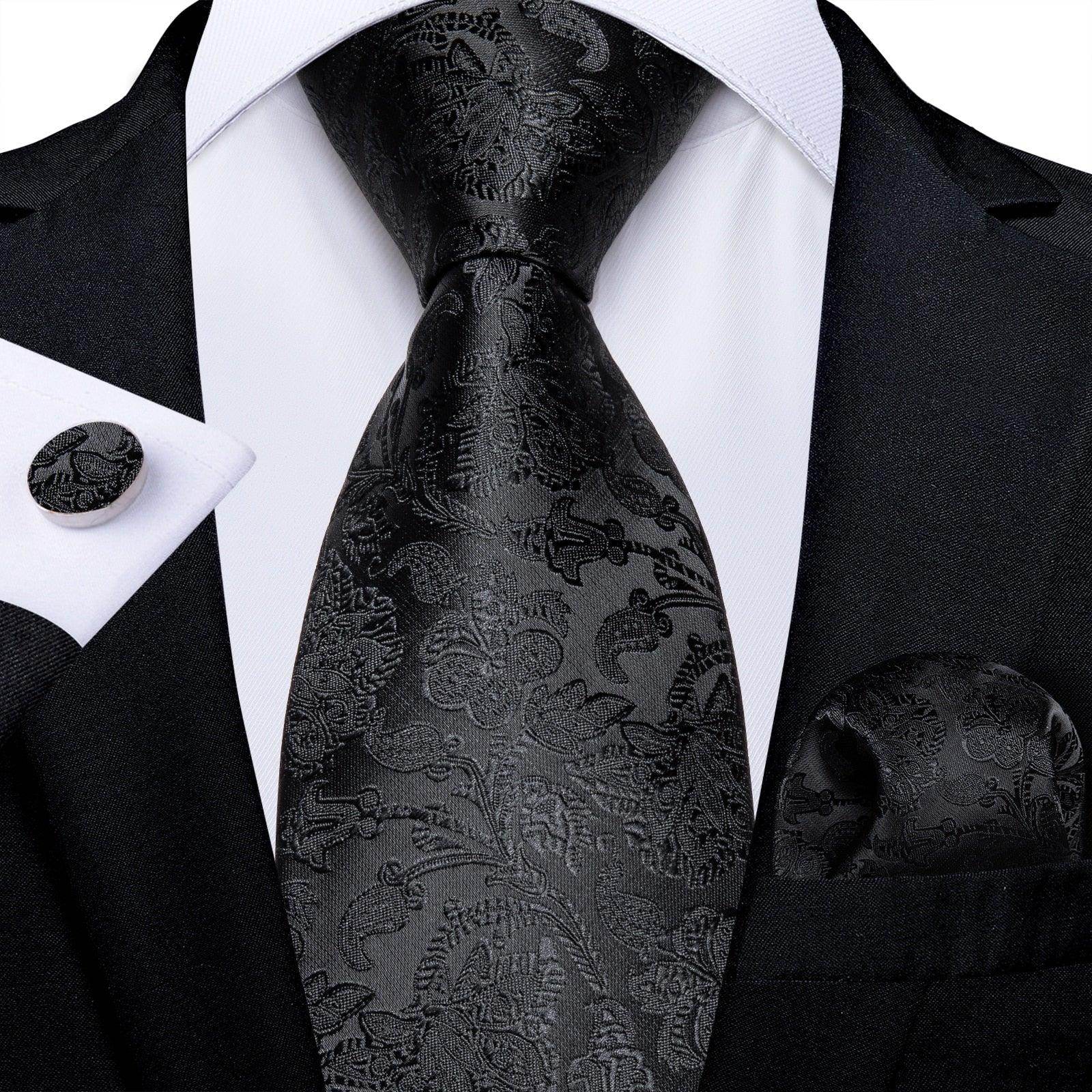 Black paisley formal neck tie for men paired with a matching pocket square and cufflink