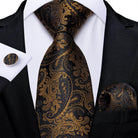 Elegant formal neck tie for men in black and gold paisley pattern with matching pocket square