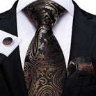 Elegant formal neck tie for men with intricate gold and black pattern, complemented by matching pocket square