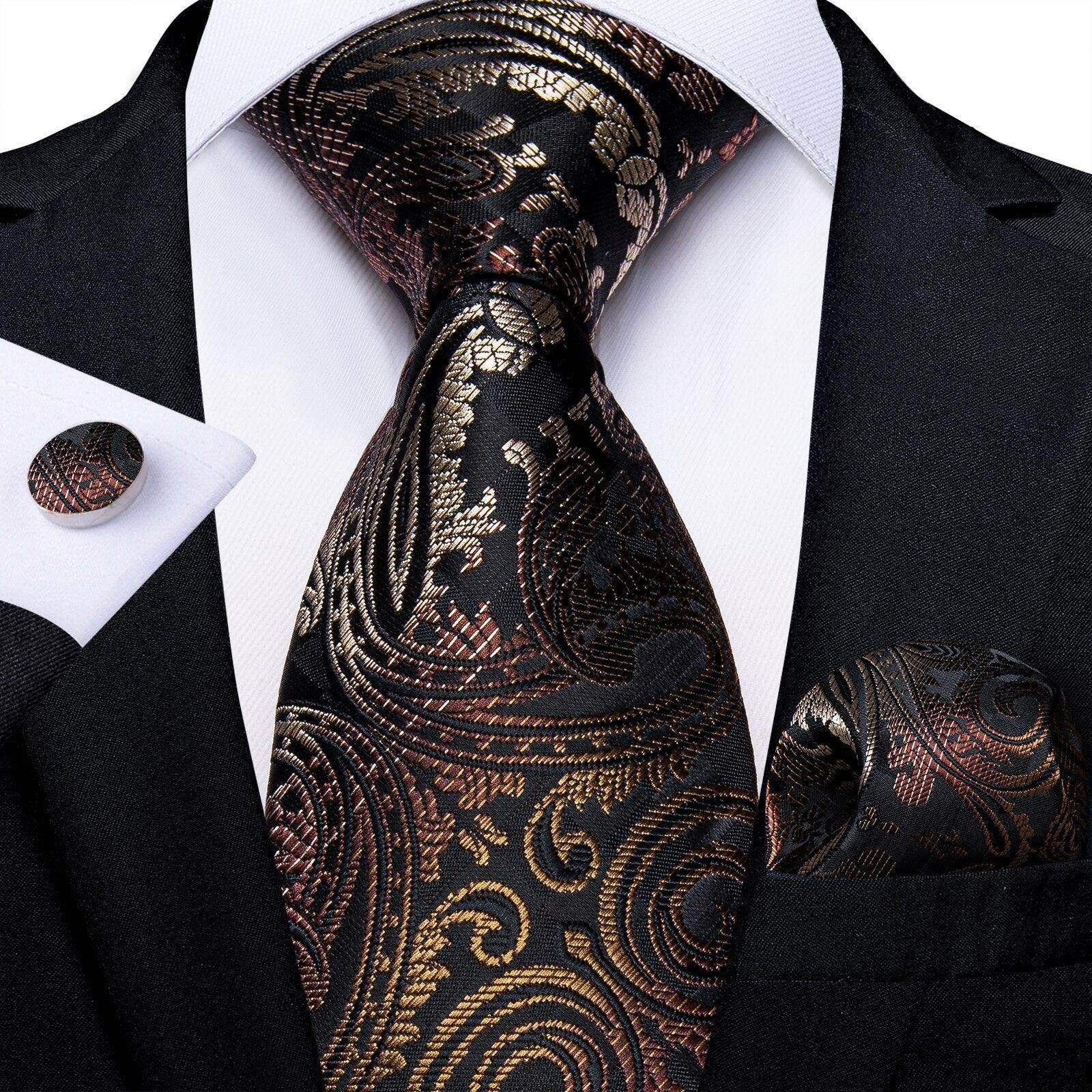Elegant formal neck tie for men with intricate gold and black pattern, complemented by matching pocket square