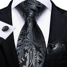 Elegant formal neck tie for men in black paisley design with matching cufflinks and pocket square