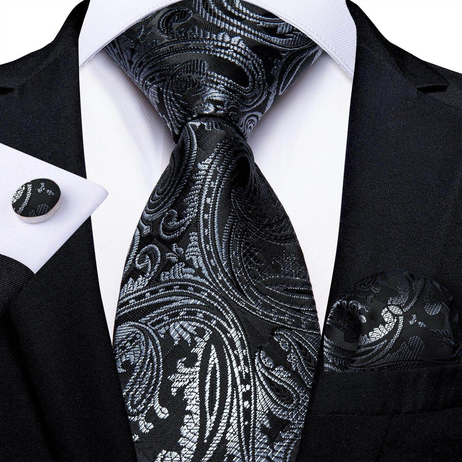 Elegant formal neck tie for men in black paisley design with matching cufflinks and pocket square
