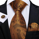 Elegant gold patterned formal neck tie for men, paired with matching pocket square and cufflinks