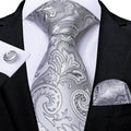 Elegant silver paisley formal neck tie for men with matching pocket square and cufflinks