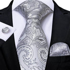 Elegant silver paisley formal neck tie for men with matching pocket square and cufflinks