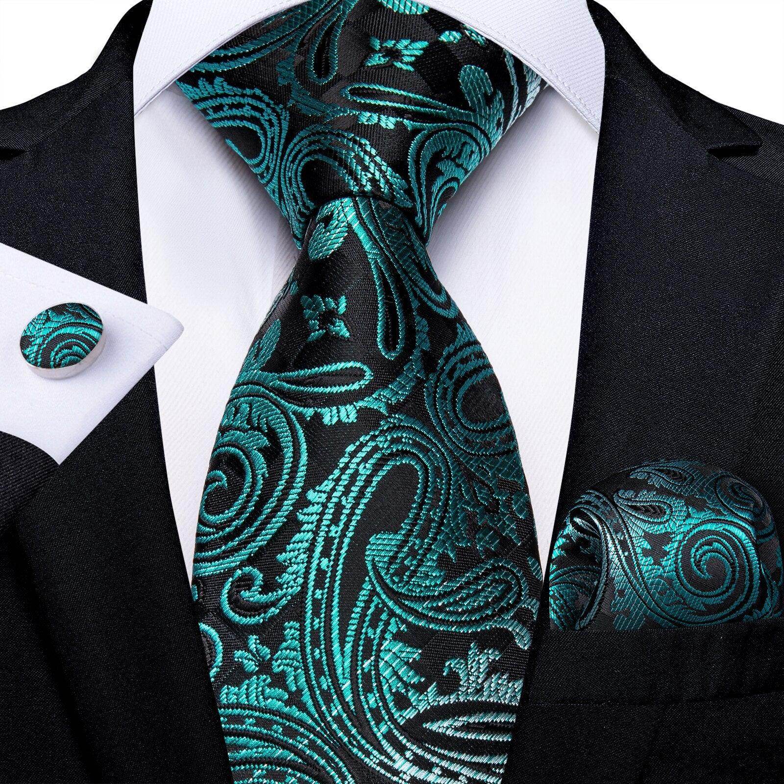 Elegant formal neck tie for men in teal and black paisley pattern, paired with matching pocket square and cufflinks