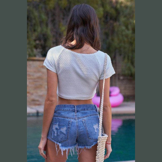 Tasha Apparel frayed hem denim shorts styled with a casual crop top for a trendy summer look