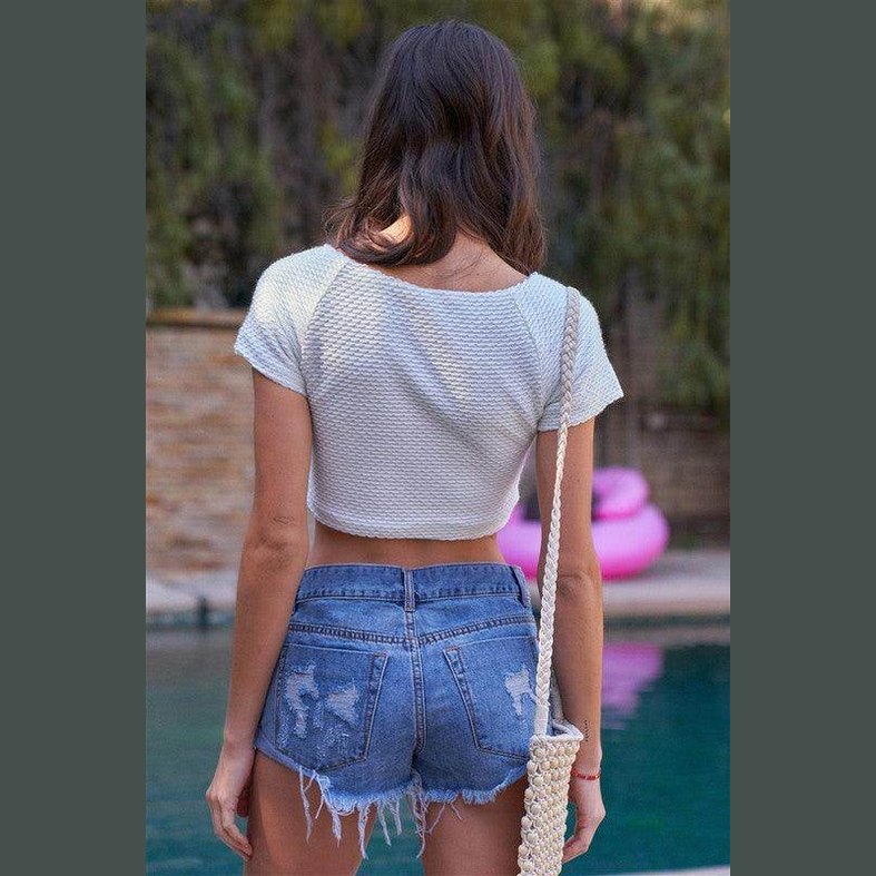Tasha Apparel frayed hem denim shorts styled with a casual crop top for a trendy summer look