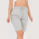 Women wearing gray french terry bermuda shorts with elastic waistband and drawstring