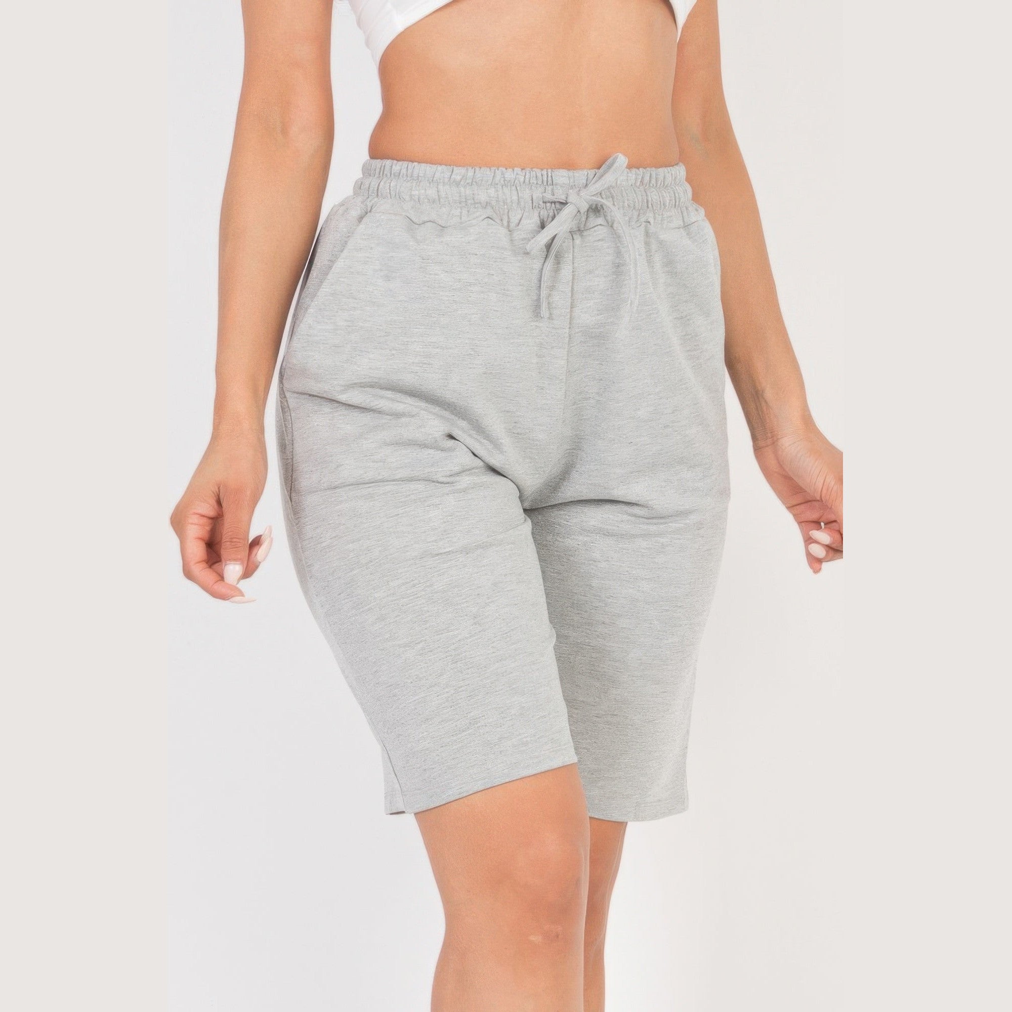 Women wearing gray french terry bermuda shorts with elastic waistband and drawstring