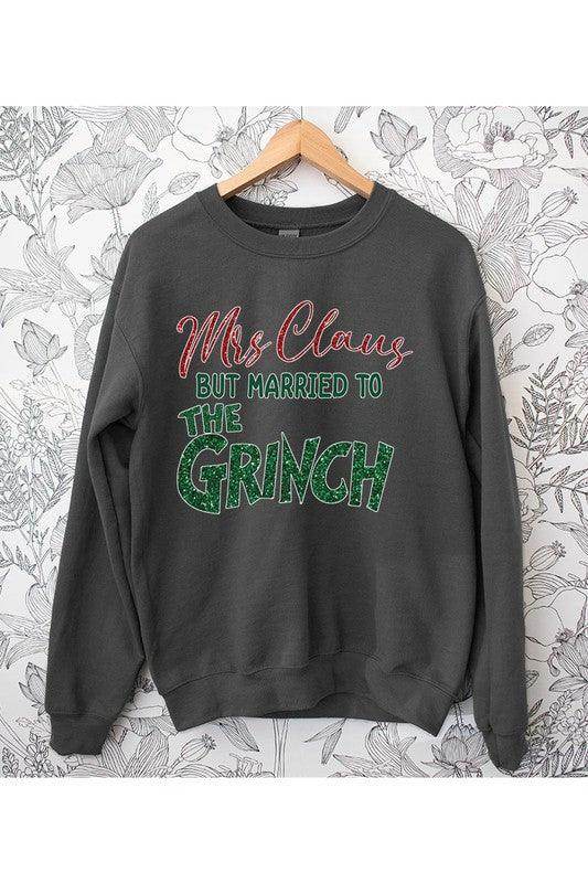 Funny Christmas sweaters featuring Mrs. Claus but married to the Grinch design on a dark sweatshirt
