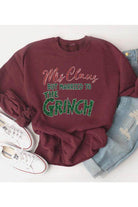 Funny Christmas sweaters featuring Mrs. Claus married to The Grinch in a festive design