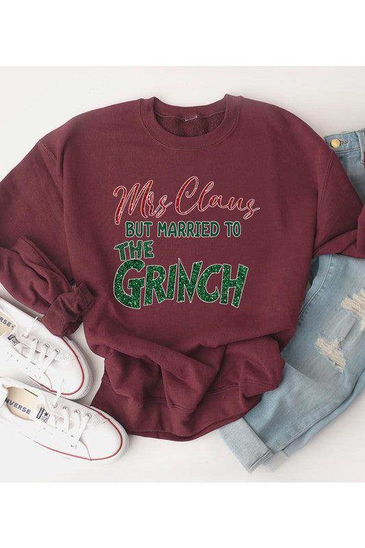 Funny Christmas sweaters featuring Mrs. Claus married to The Grinch in a festive design