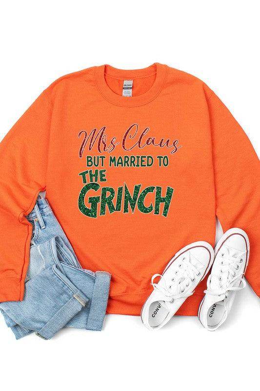 Funny Christmas sweaters featuring orange Mrs Claus design married to the Grinch with jeans and sneakers