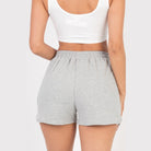 VacationGrabs gray french terry shorts for women with elastic waistband on model back view