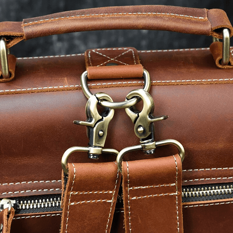 Close-up of a genuine leather backpack for travel featuring sturdy metal clasps and detailed stitching
