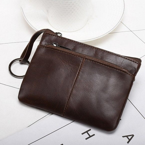 Genuine leather coin wallet in dark brown with zipper pocket and wrist strap for convenience