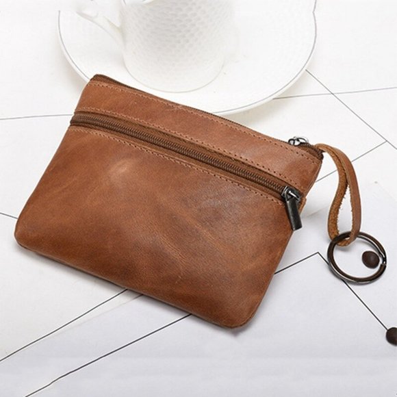 Stylish genuine leather coin wallet in brown with zipper closure and wrist strap for easy carrying