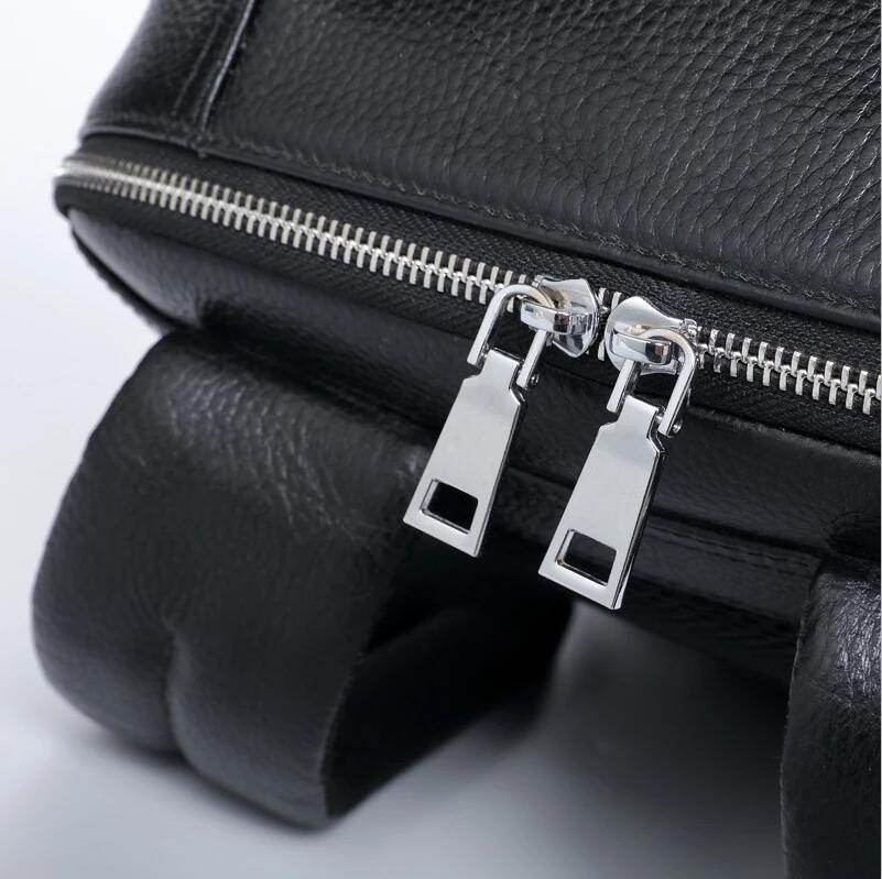 Close-up of genuine leather laptop backpack featuring durable zippers and stylish design