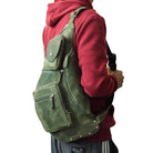 Genuine leather mens chest bag in green, worn on shoulder for stylish and practical use.