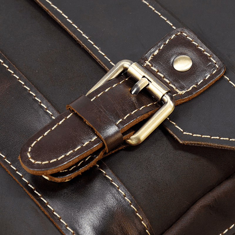 Close-up of genuine leather travel backpack hardware and stitching details showcasing craftsmanship
