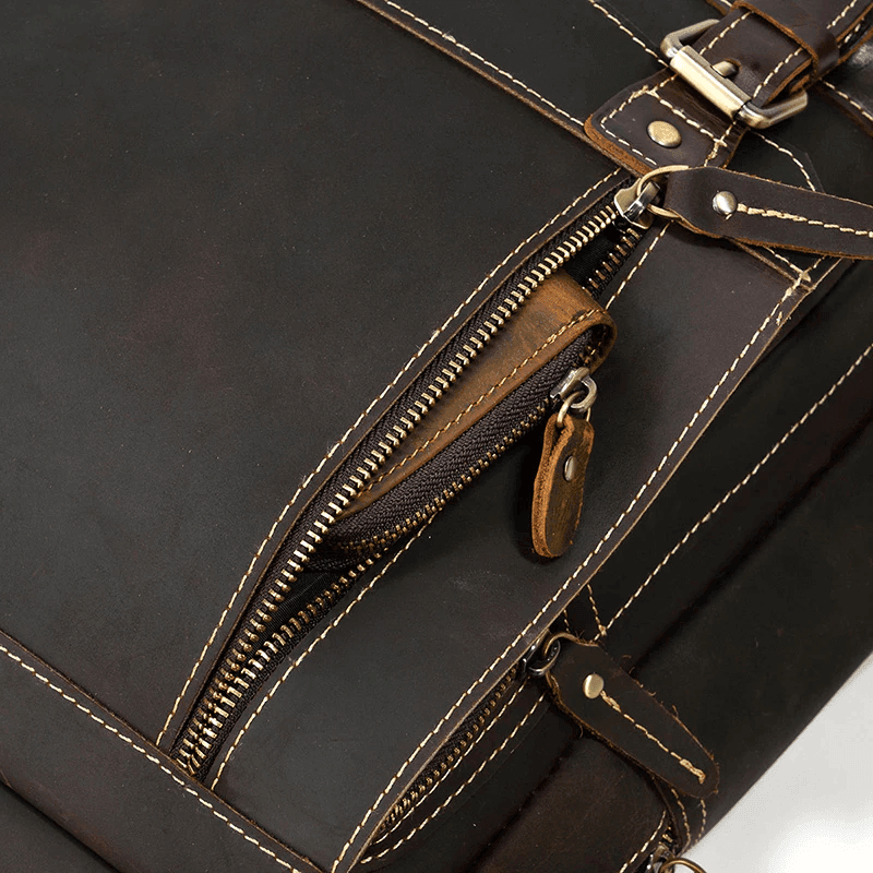 Genuine leather travel backpack featuring durable zippers and sturdy buckles for secure storage