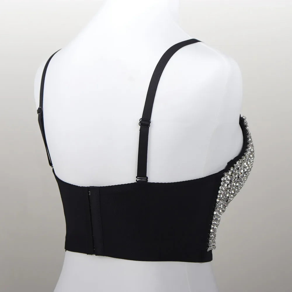 Black rhinestone crop top party outfit with adjustable straps and hook back closure on mannequin