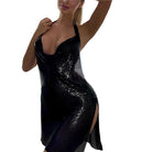 Black glitter backless mini dress with halter neckline and side slit on woman