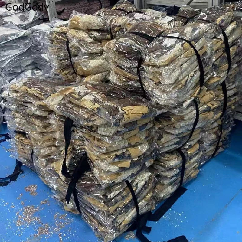 Bulk packages of punk vintage ruffle skirt outfit costume wrapped in plastic and stacked for shipment