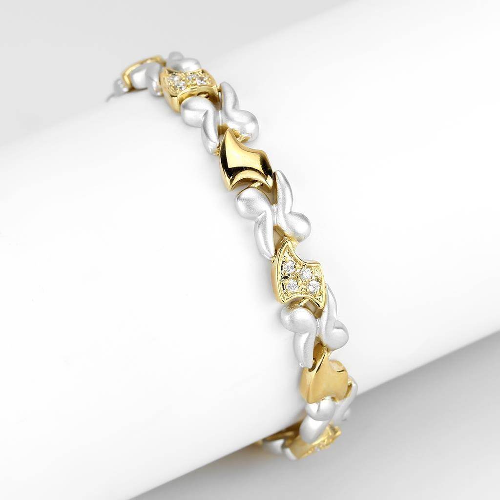Elegant gold and rhodium women's bracelet featuring intricate designs and sparkling accents
