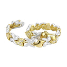 Elegant gold and rhodium women's bracelet featuring shimmering accents and a unique design