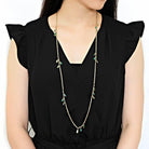 Stylish gold brass necklace for women featuring delicate green accents and a long chain design