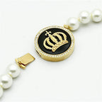Gold crown pendant necklace for women with a pearl chain and elegant design