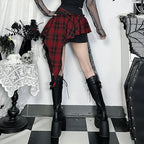 Goth plaid skirt for women in red and black with asymmetrical design paired with black mesh top and knee-high boots