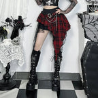 Woman wearing a goth plaid skirt for women with chains and black platform boots in a gothic room setting