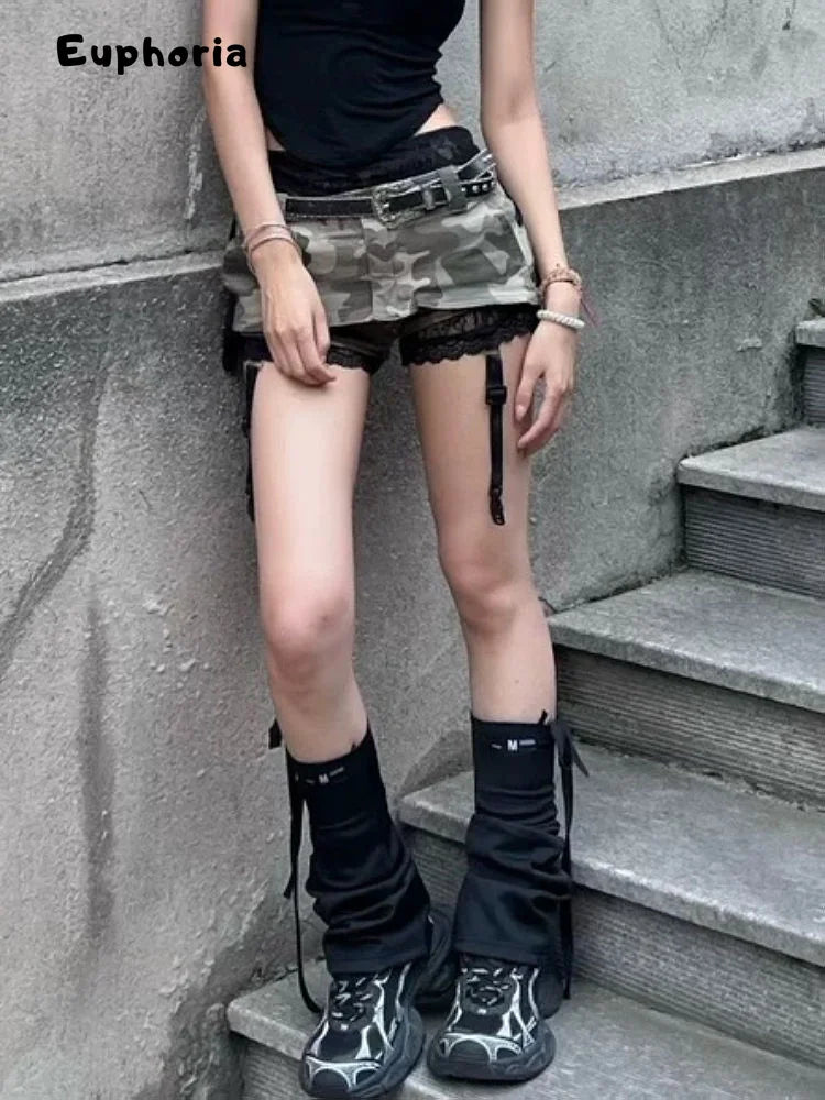 Woman wearing a gothic punk camouflage skirt paired with black lace shorts and black high boots