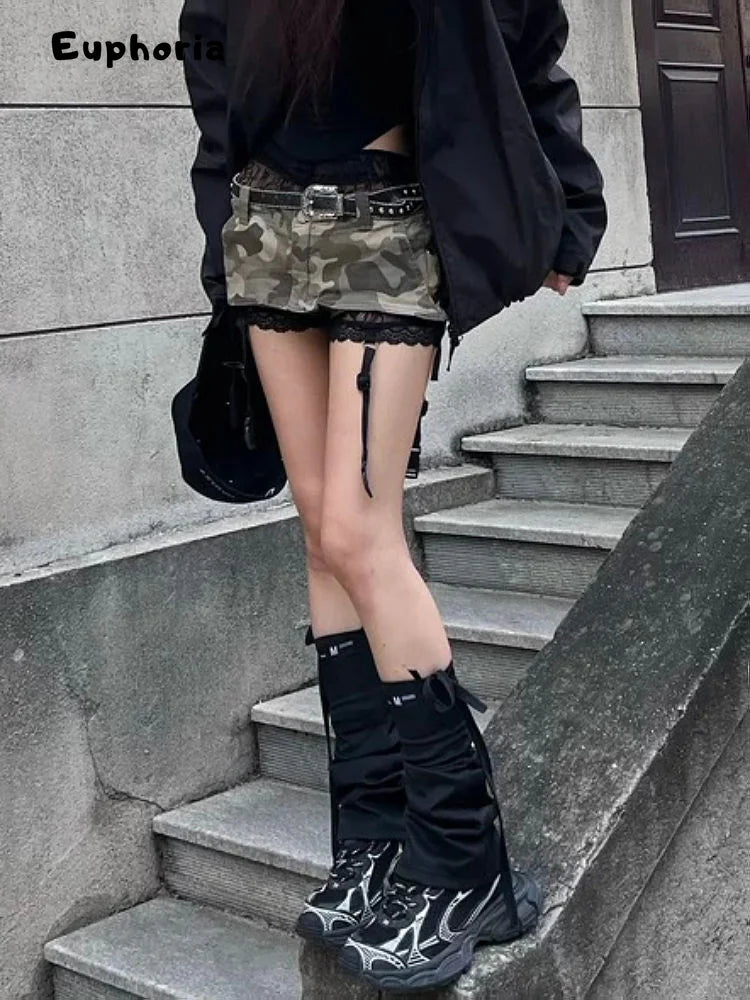 Gothic punk camouflage skirt styled with black jacket and boots on outdoor stairs