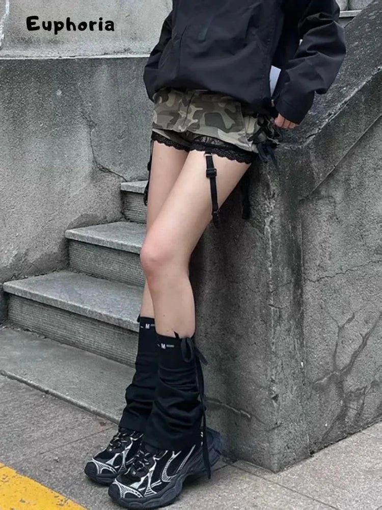 Woman wearing a gothic punk camouflage skirt paired with black jacket and unique flame-patterned boots