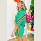 YNIQUE green colorblock lounge set with multicolor stripes worn by woman with casual cap