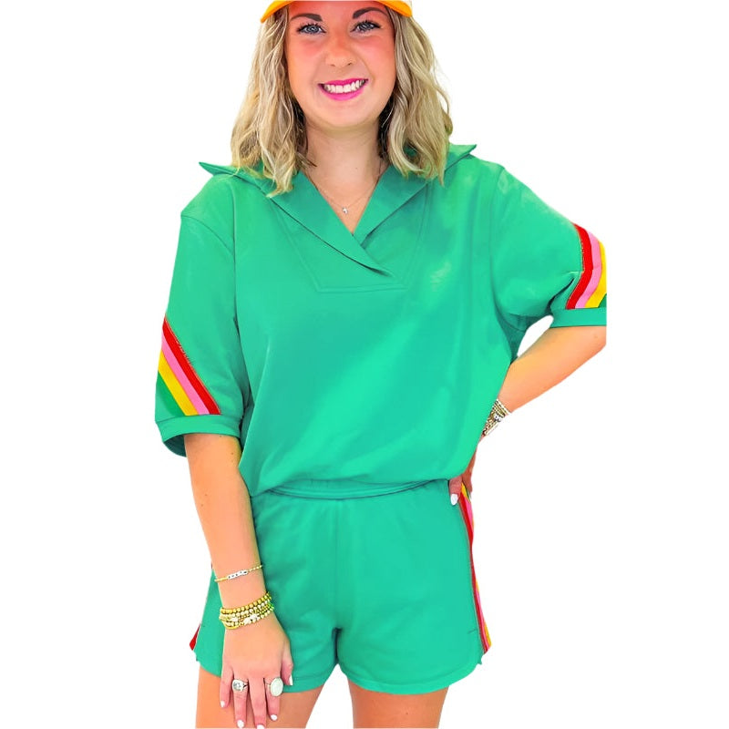 YNIQUE green colorblock lounge set with rainbow stripes on sleeves and sides worn by woman