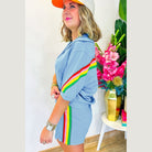 Woman wearing YNIQUE green colorblock lounge set with rainbow stripes on sleeves and skirt